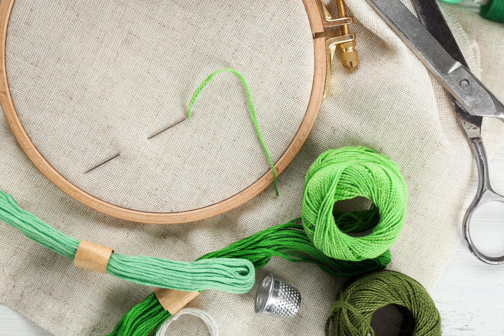 atelier table with embroidery hoop and threads